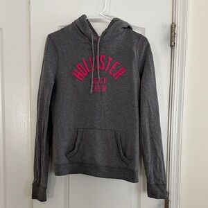 Hollister Dark Gray Hoodie with Vibrant Pink Text